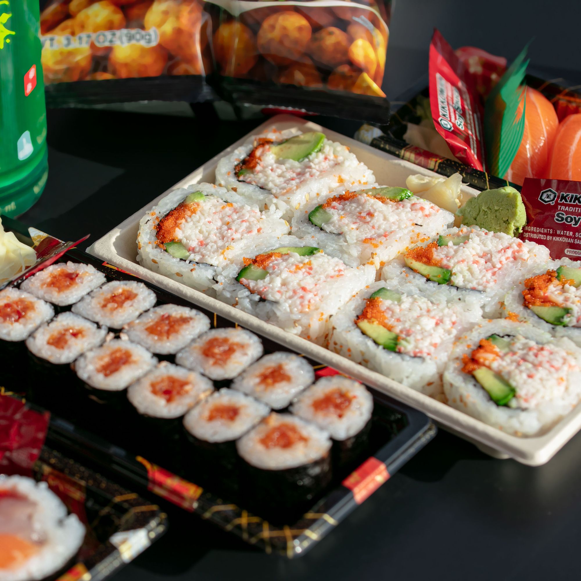 Assorted sushi rolls on dark board